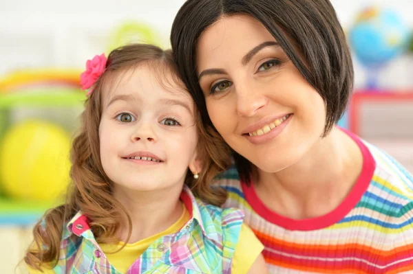 Young mother hugging with little daughter — Stock Photo, Image