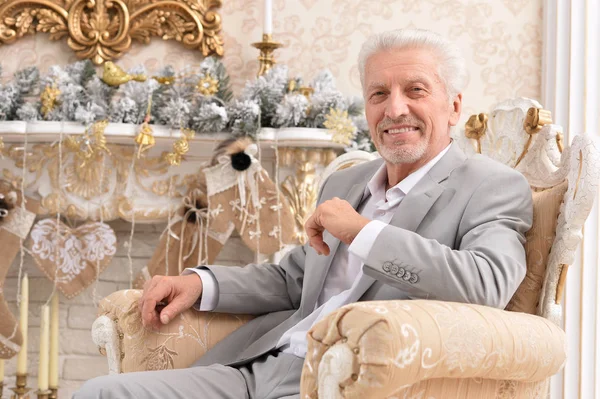 Portrait Confident Senior Businessman Sitting Chair Room Decorated Christmas Holiday — Stock Photo, Image