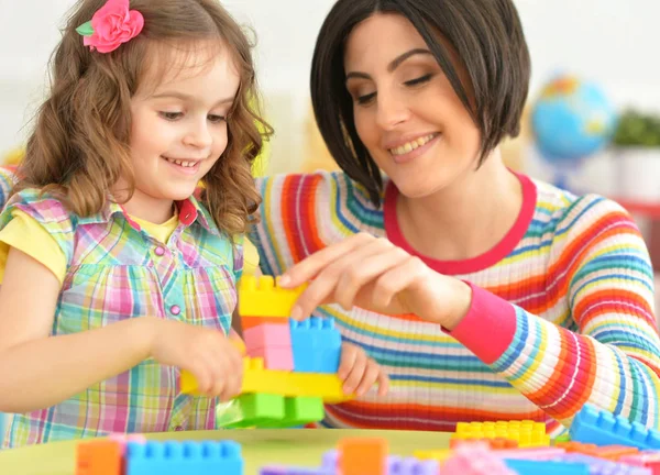 Young mother playing with little daughter — Stock Photo, Image