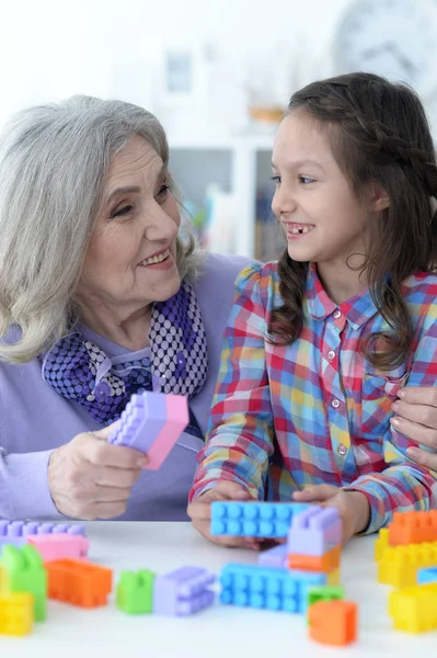 Girl playing with plastic blocks — Stock Photo, Image