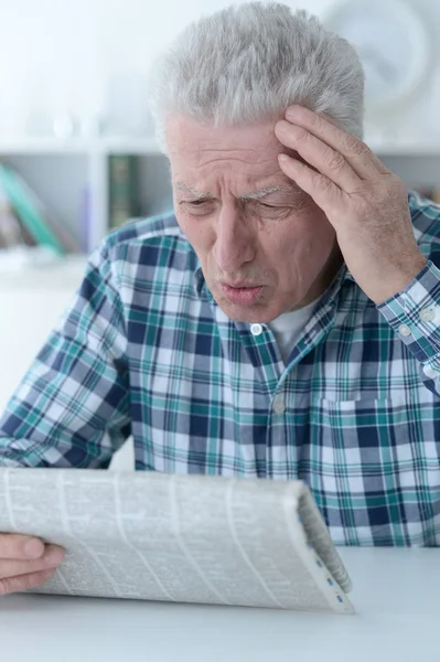 Emotional Senior Man Reading Newspaper Home — Stock Photo, Image