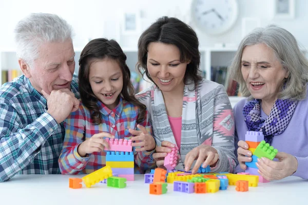 Girl playing with plastic blocks — Stock Photo, Image