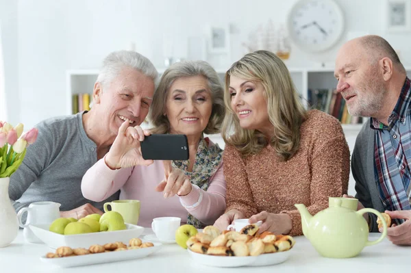 Zwei Senioren Paare Beim Morgendlichen Tee Küchentisch Mit Smaertphone — Stockfoto