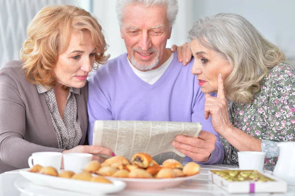 Personas Mayores Felices Leyendo Periódico Mientras Beben Con Galletas Cocina — Foto de Stock