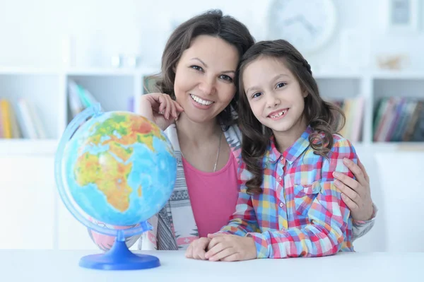 Thoughtful Mother Daughter Sitting Table Globe — Stock Photo, Image