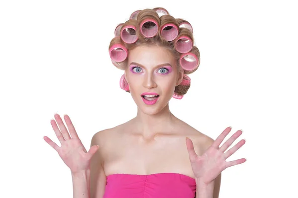 Woman in pink dress with hair curlers — Stock Photo, Image