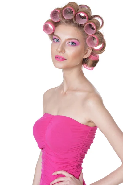 Woman in pink dress with hair curlers — Stock Photo, Image