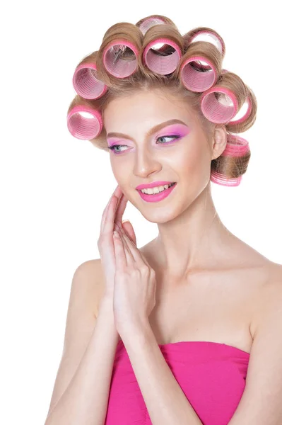 Woman in pink dress with hair curlers — Stock Photo, Image