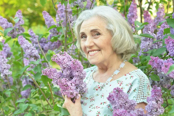 Szczęśliwa Seniorka Piękna Kobieta Bzu Wiosennym Parku — Zdjęcie stockowe