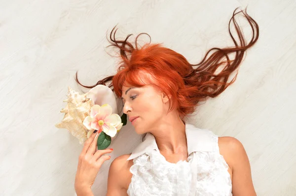 花でポーズ美しい赤毛成熟した女性 — ストック写真