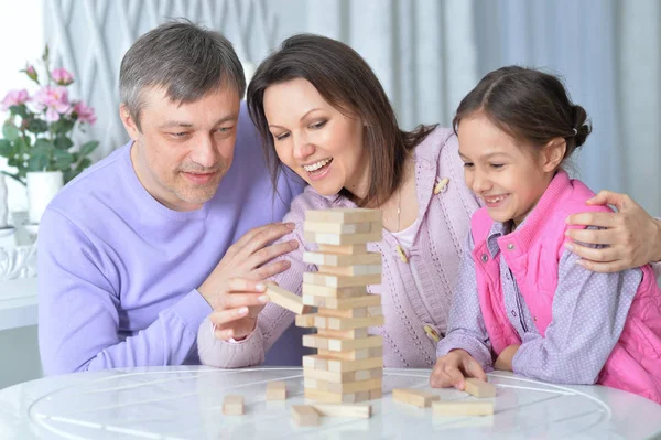 Glückliche Familie sitzt und spielt — Stockfoto