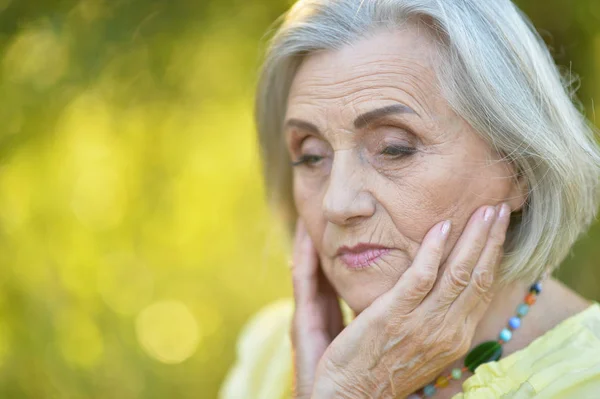 Üzgün Yaşlı Güzel Bir Kadın Bahar Parkında — Stok fotoğraf