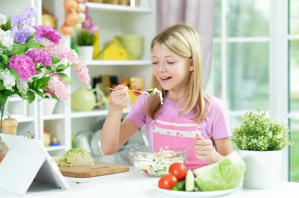 Cute Little Girl Preparing Fresh Salad Kitchen Table Tablet Home — Stock Photo, Image