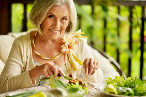 Portrait of beautiful senior woman eating healthy breakfast