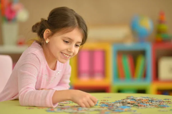 Cute Little Girl Collecting Puzzle Pieces — Stock Photo, Image