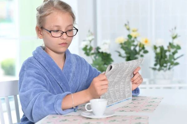 Ładna Dziewczyna Okulary Niebieski Szlafrok Czytanie Gazety — Zdjęcie stockowe