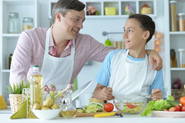 father and son cooking breakfast in the kitchen