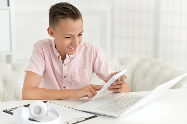 Rapaz Bonito Usando Calculadora Enquanto Sentado Mesa Com Laptop Quarto — Fotografia de Stock