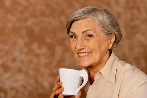 Beautiful Smiling Senior Woman Drinking Tea Home — Stock Photo, Image