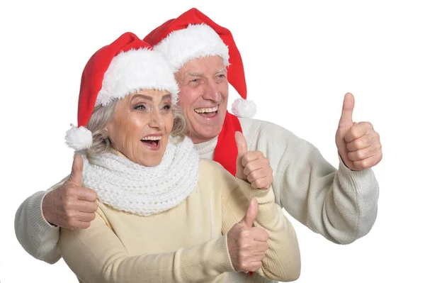 Seniorpaar mit Weihnachtsmann-Hüten — Stockfoto