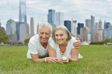 portrait of beautiful senior couple  on grass clipart