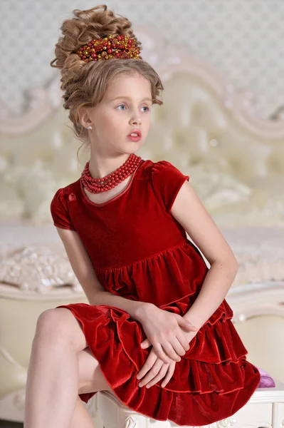 Linda Niña Vestido Rojo Sentado Dormitorio —  Fotos de Stock