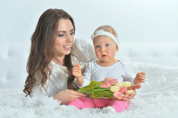 Young woman playing with little daughter — Stock Photo, Image