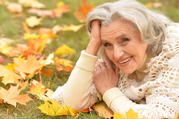 Senior Mooie Vrouw Liggend Bladeren — Stockfoto