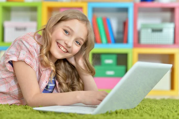 Симпатичная Девушка Использует Ноутбук Лежа Зеленом Полу Дома — стоковое фото