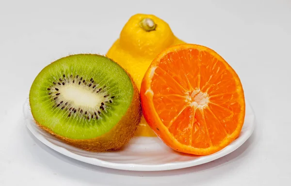 Colored fruit on white background.