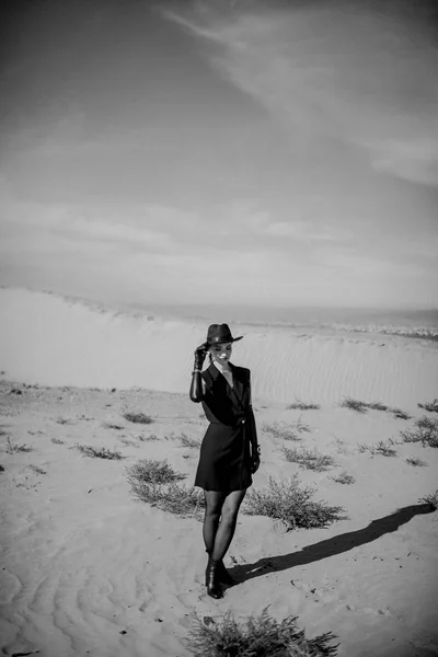 Girl in black in desert