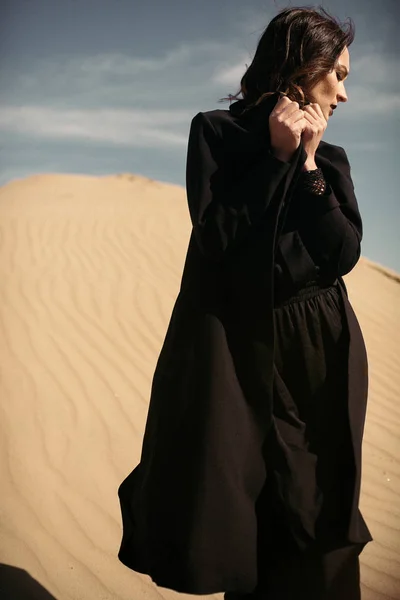 Girl in Black dress in desert