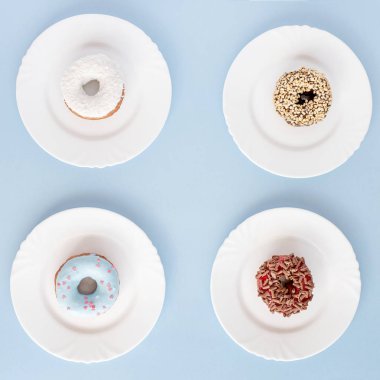 Sır mavi bir masada beyaz plakaları kaplı çörek