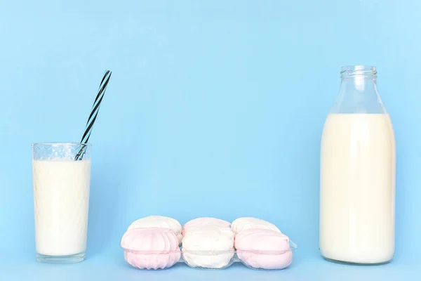 Milk in  glass bottle and in  glass and set of marshmallows