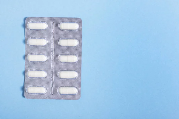 Capsule bianche con farmaci in confezione — Foto Stock