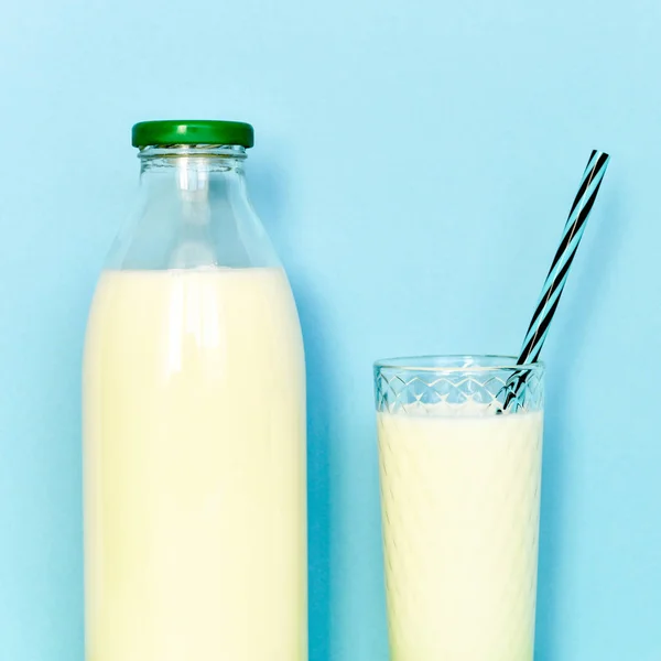 Lait dans une bouteille en verre et un verre transparent avec paille — Photo