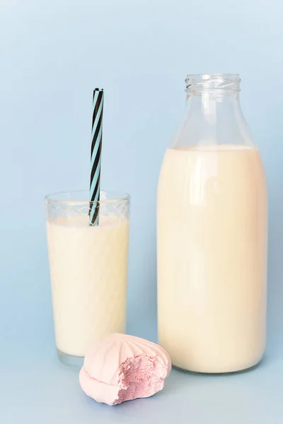 Milk in  glass bottle and in  glass and marshmallow