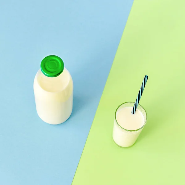 Lait dans une bouteille en verre et un verre transparent avec paille — Photo