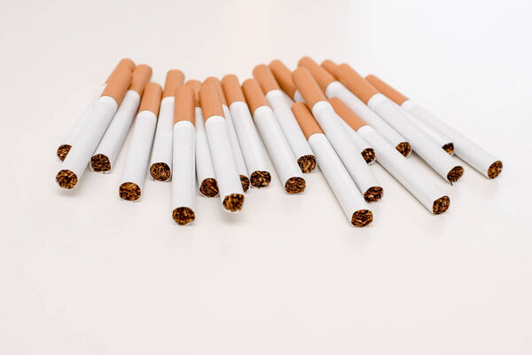 Pack of cigarettes with orange filter on white