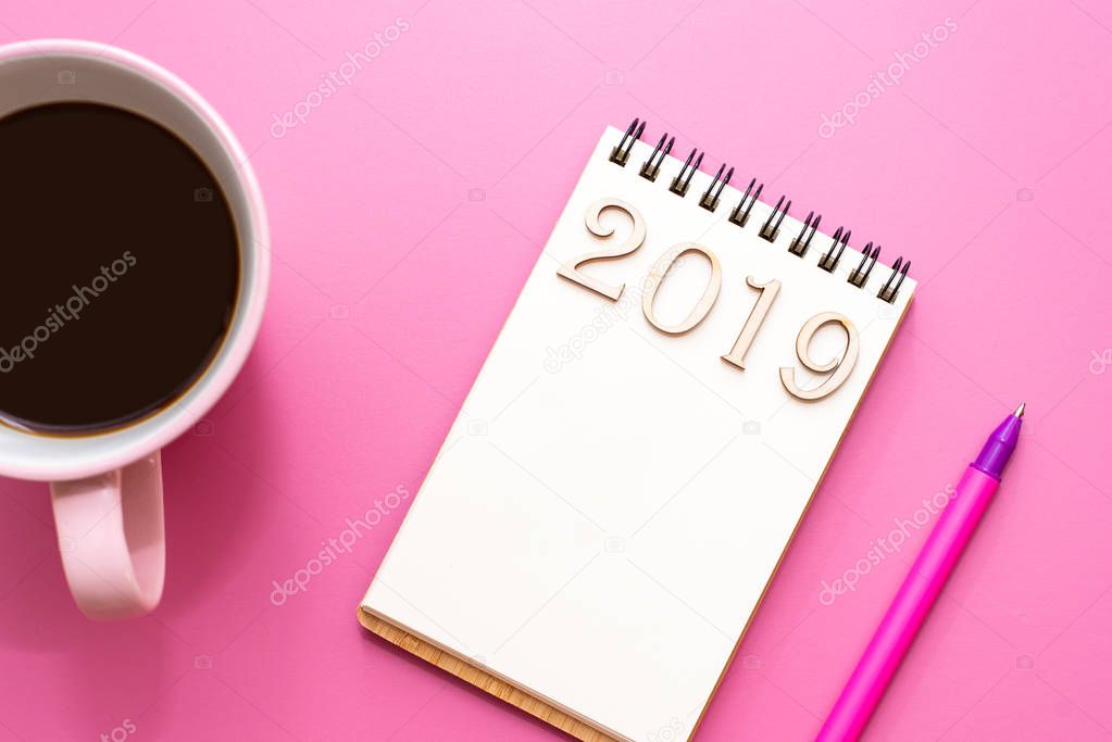 Top view 2019 list with notebook, cup of coffee