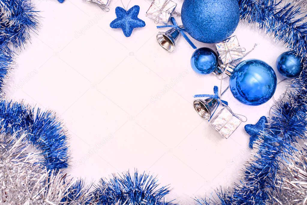 Flat lay consisting of blue Christmas toys and tinsel