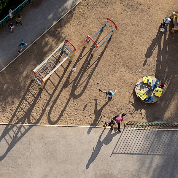 Παιδιά κυνηγήσει την μπάλα στην αυλή στην παιδική χαρά στο Sunny σαφές μέρα του καλοκαιριού — Φωτογραφία Αρχείου