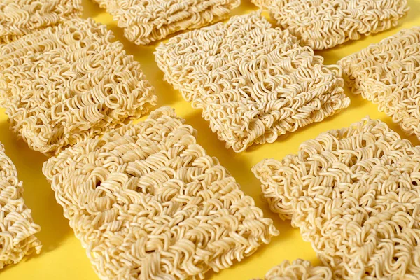 Instant noodles on a yellow background