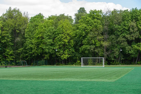 Football goal on the field with artificial turf in the city Park