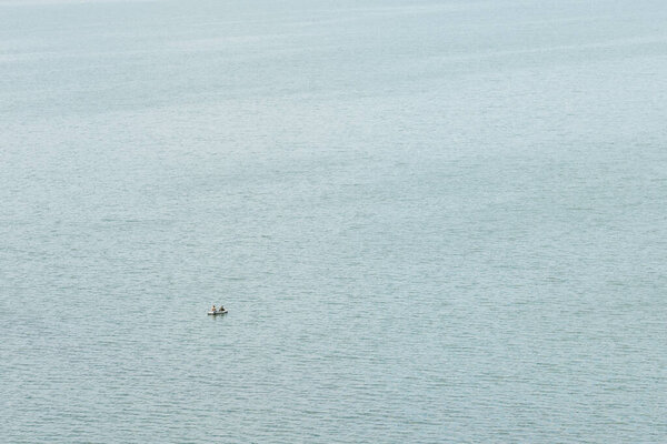 A fisherman is fishing in the lake on a clear summer day. Fishing. Hobby. Weekend. Rest.