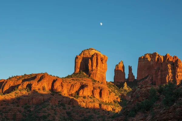 the full moon rising over cathedral rocks Sedona Arizona in fall