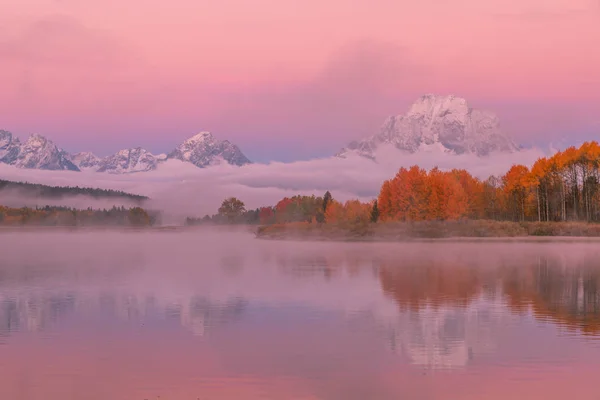 a scenic reflection of the Tetons at sunrise in autumn