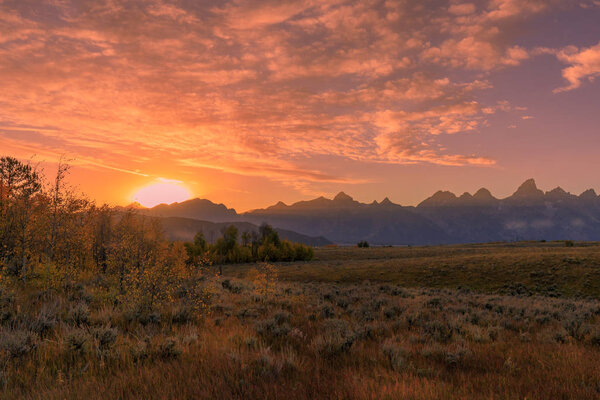 A scenic sunset landscape in the Tetons in autumn