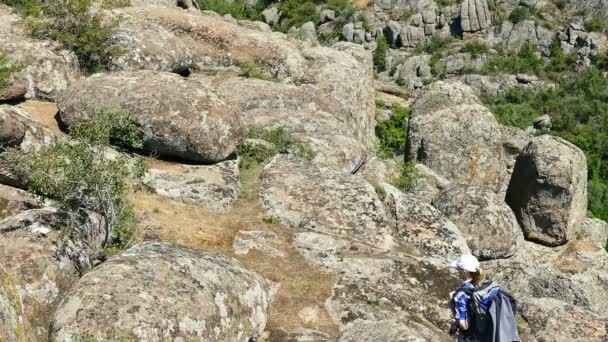 女性観光客のバックパックは 岩の峡谷に行きます 夏の青空 — ストック動画