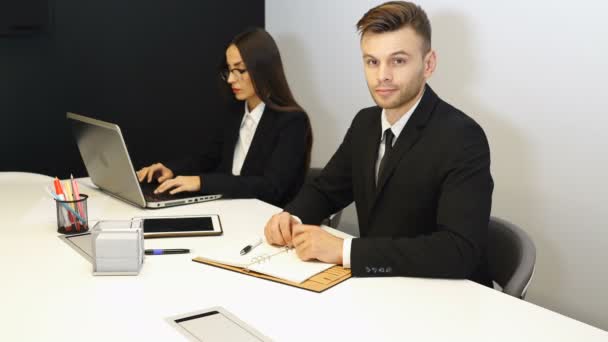 Young Handsome Man Smiles Shows Hand Camera Office Work Area — Stock Video